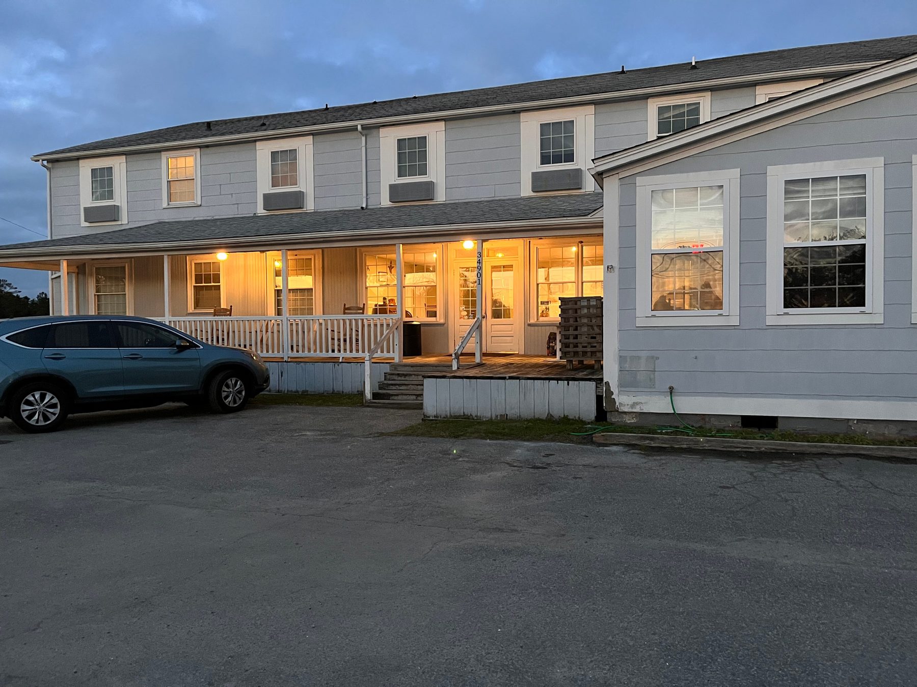Hotel Engelhard at dusk — the lit front porch with rocking chairs, on U.S. 264 in Engelhard, North Carolina